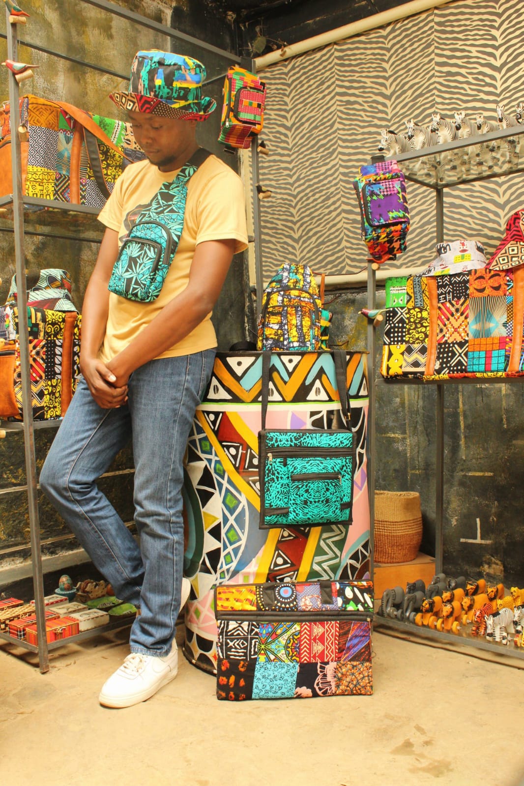 Gallery styling with hats, bags and colorful textile accessories.