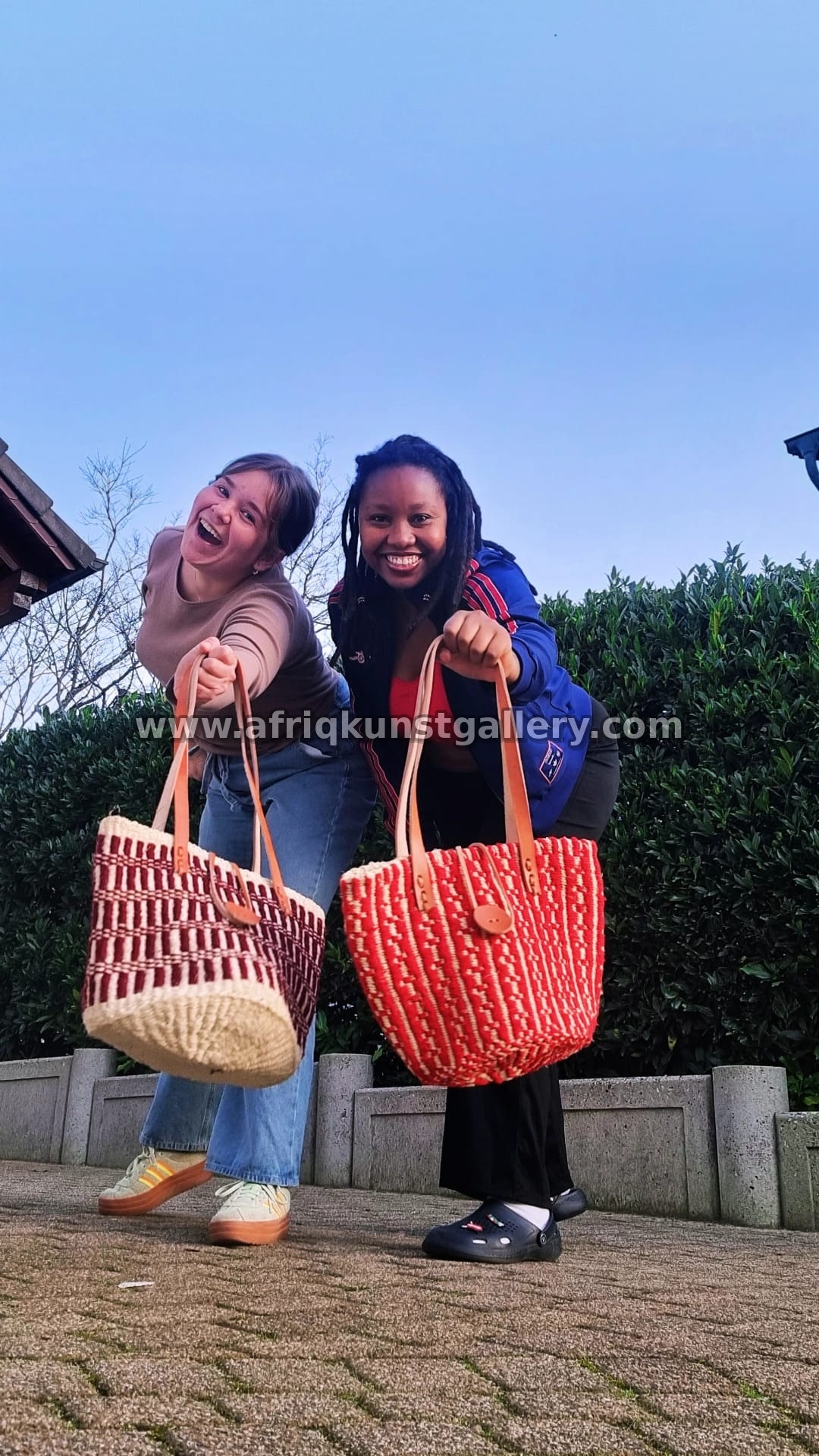 Two customers holding woven basket bags outdoors.