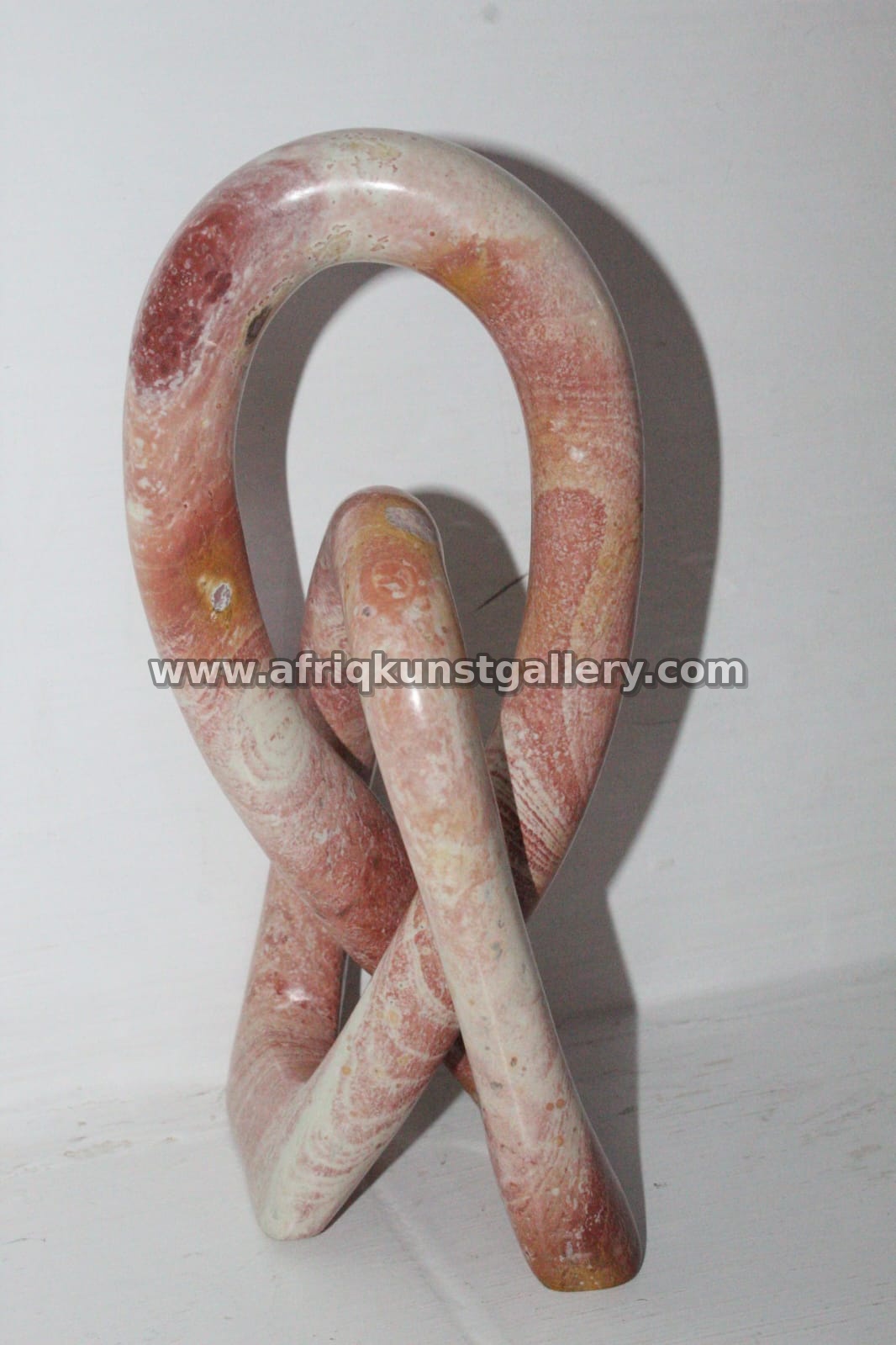 Pink Soapstone Loop Knot Sculpture.