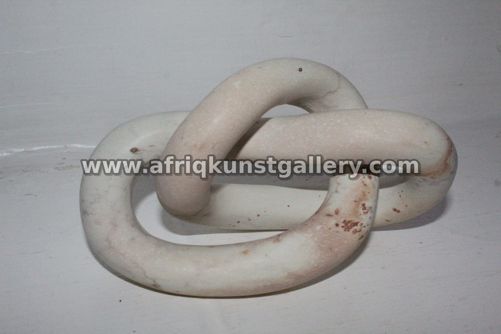 White & Pink Horizontal Soapstone Knot Sculpture.