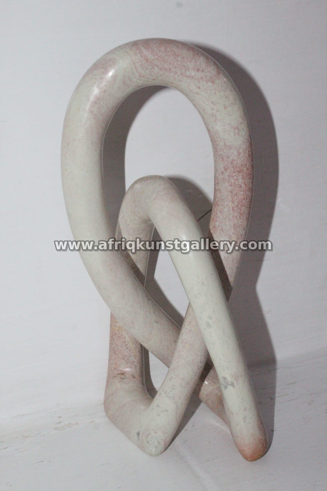 White & Pink Soapstone Loop Knot Sculpture.