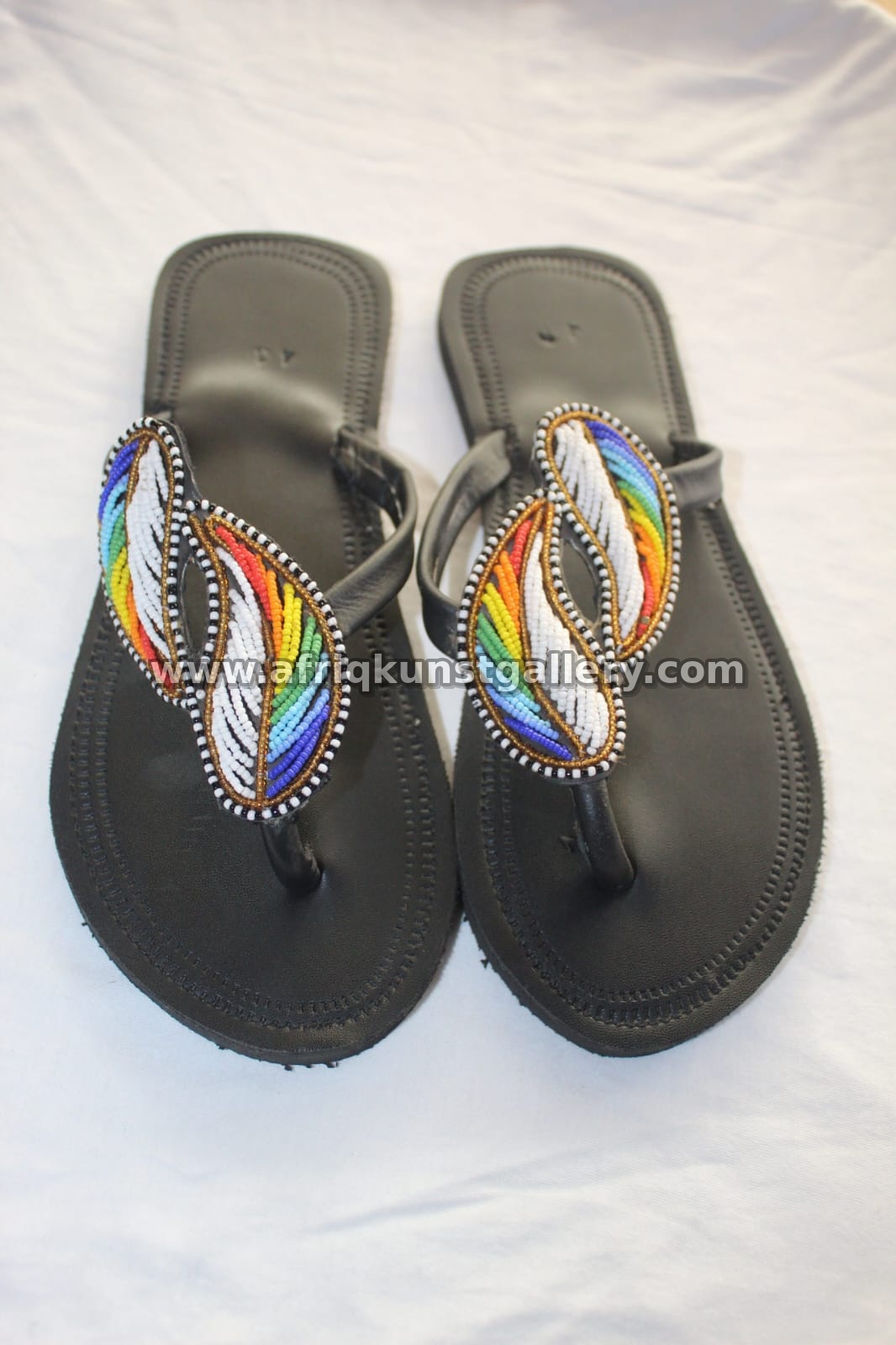 Black leather sandals with colorful beaded straps.