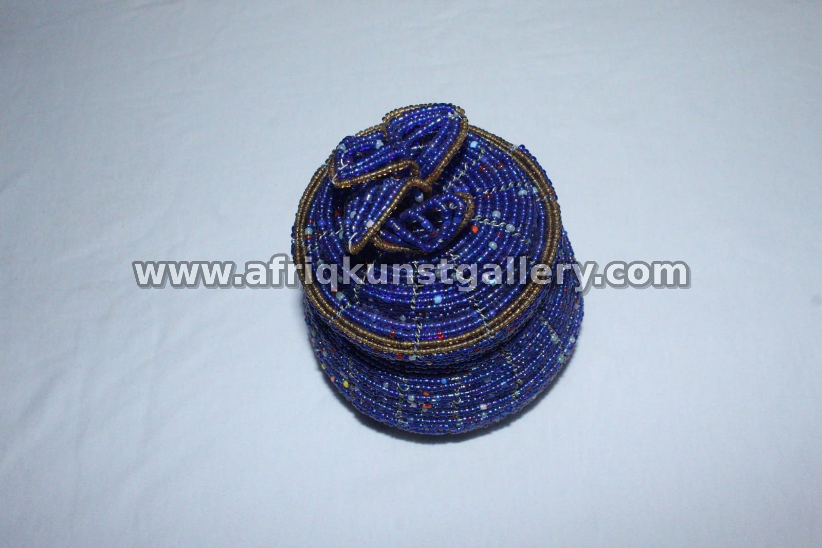 Blue round soapstone treasure box with hand-painted bead-like patterns.