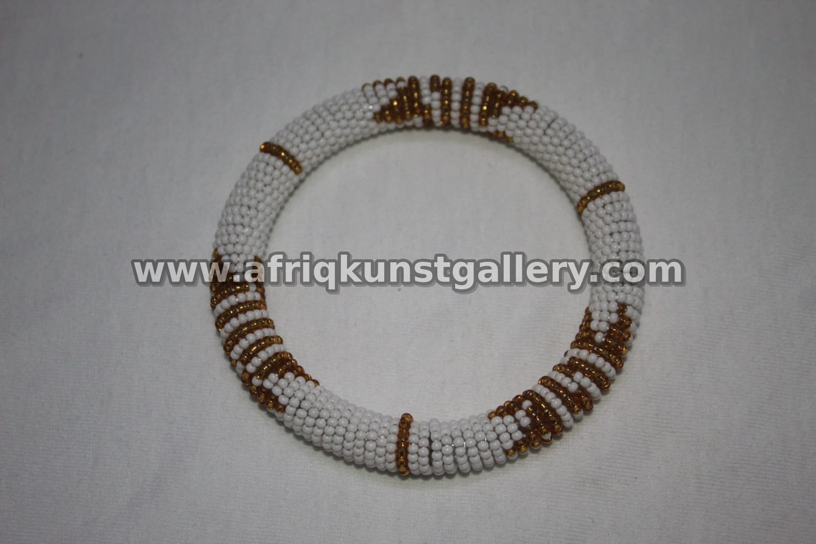 White and brown beaded choker necklace with geometric accents.
