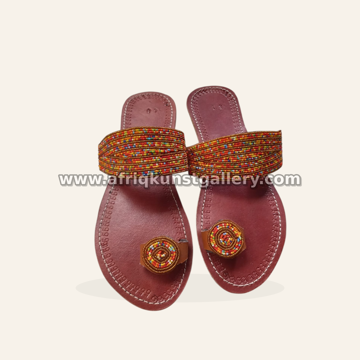 Amber-toned slide sandals with tightly beaded straps.