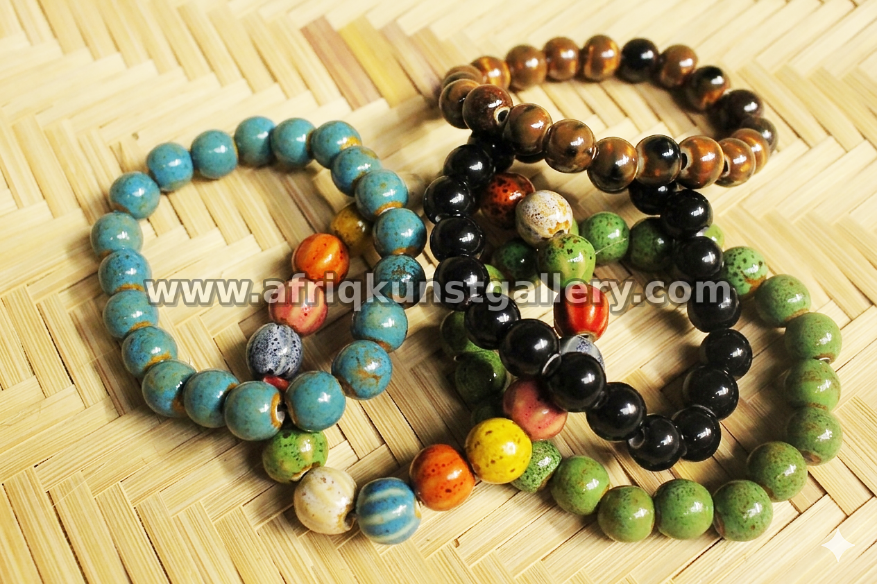 Assorted ceramic bead bracelets in blue, green, black and brown tones.