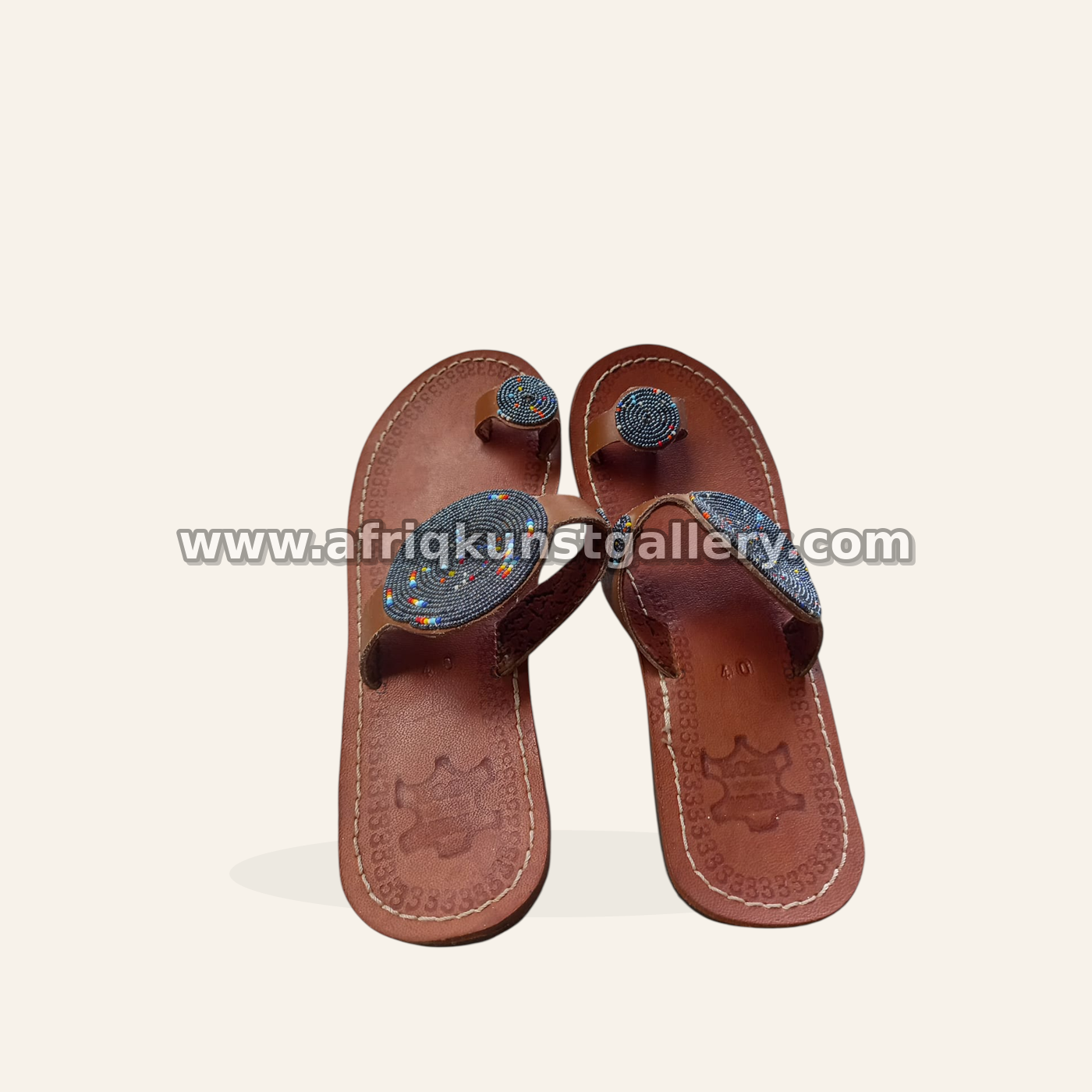 Brown leather sandals with graphite beaded medallions.
