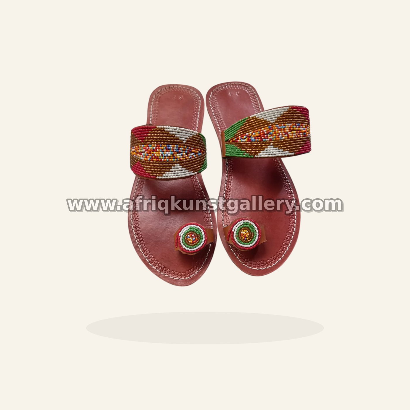 Beaded slide sandals with a multicolor band and toe medallions.