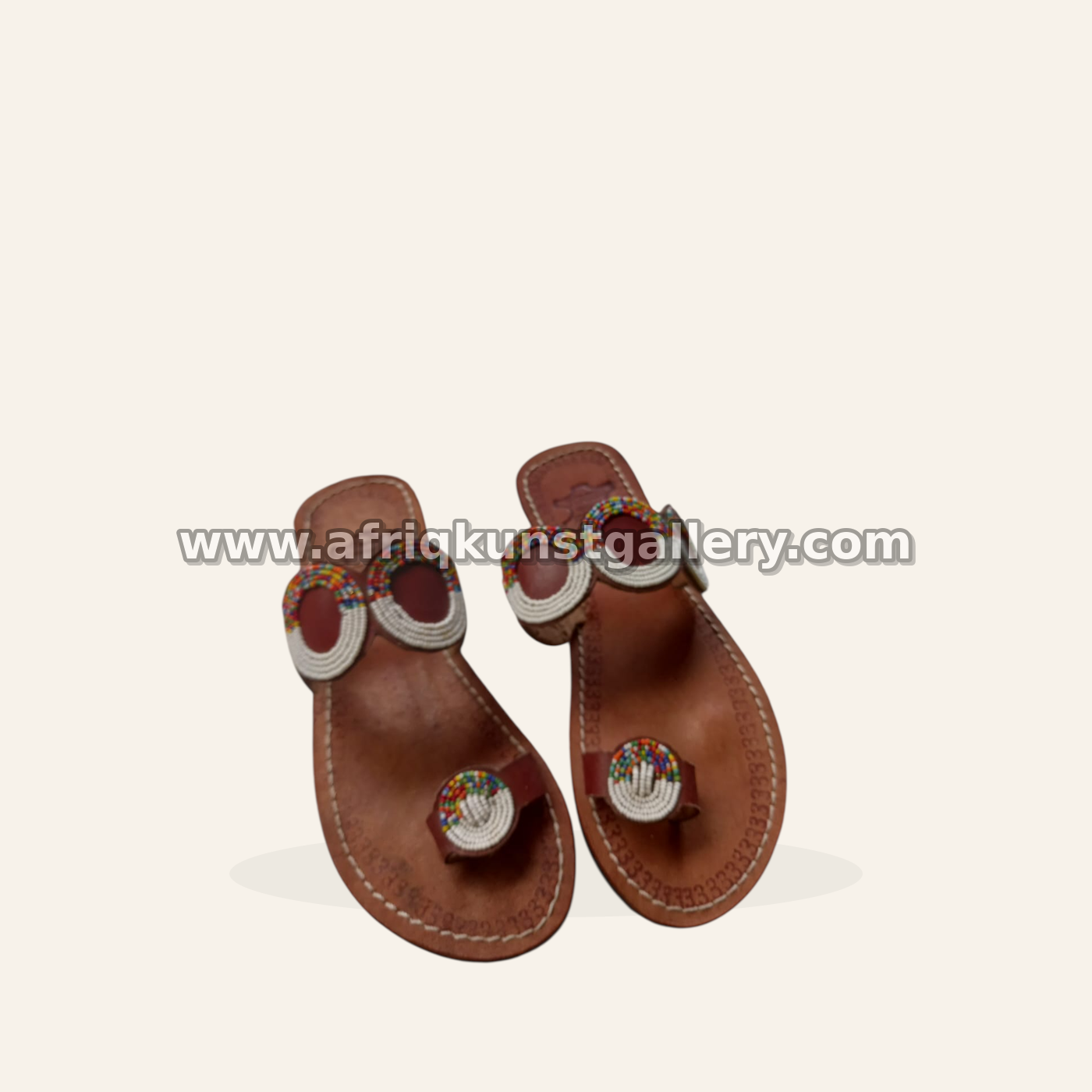 Brown sandals with white and rainbow loop beadwork.